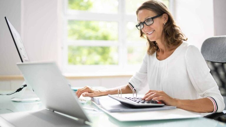 Bookkeeper looking at their computer thinking about selling their business